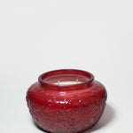 17 oz scented candle in a red embossed glass jar with two wicks