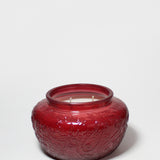 17 oz scented candle in a red embossed glass jar with two wicks