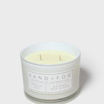 Vanilla-scented candle in frosted glass with cream wax and 'SAND+FOG' label