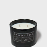 Black jar scented candle with two wicks and Sand+Fog label