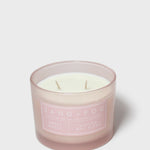 Pink glass jar scented candle with white wax and Sand + Fog label