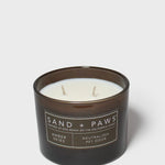 12 oz scented candle in dark glass jar with white wax and two wicks, amber skies label