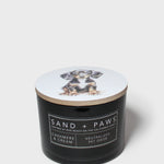 Black jar scented candle with Sand + Paws label; cashmere cream neutralized odor