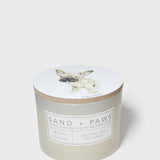 Scented candle jar with dog illustration lid and front scent label