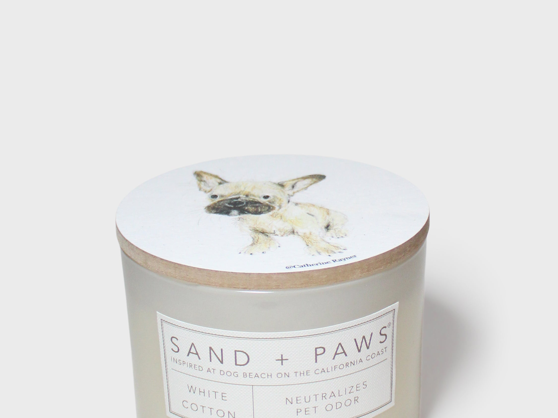 Scented candle jar with dog illustration lid and front scent label