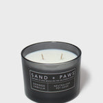 Orange vanilla scented candle with two wicks; dog label on dark jar