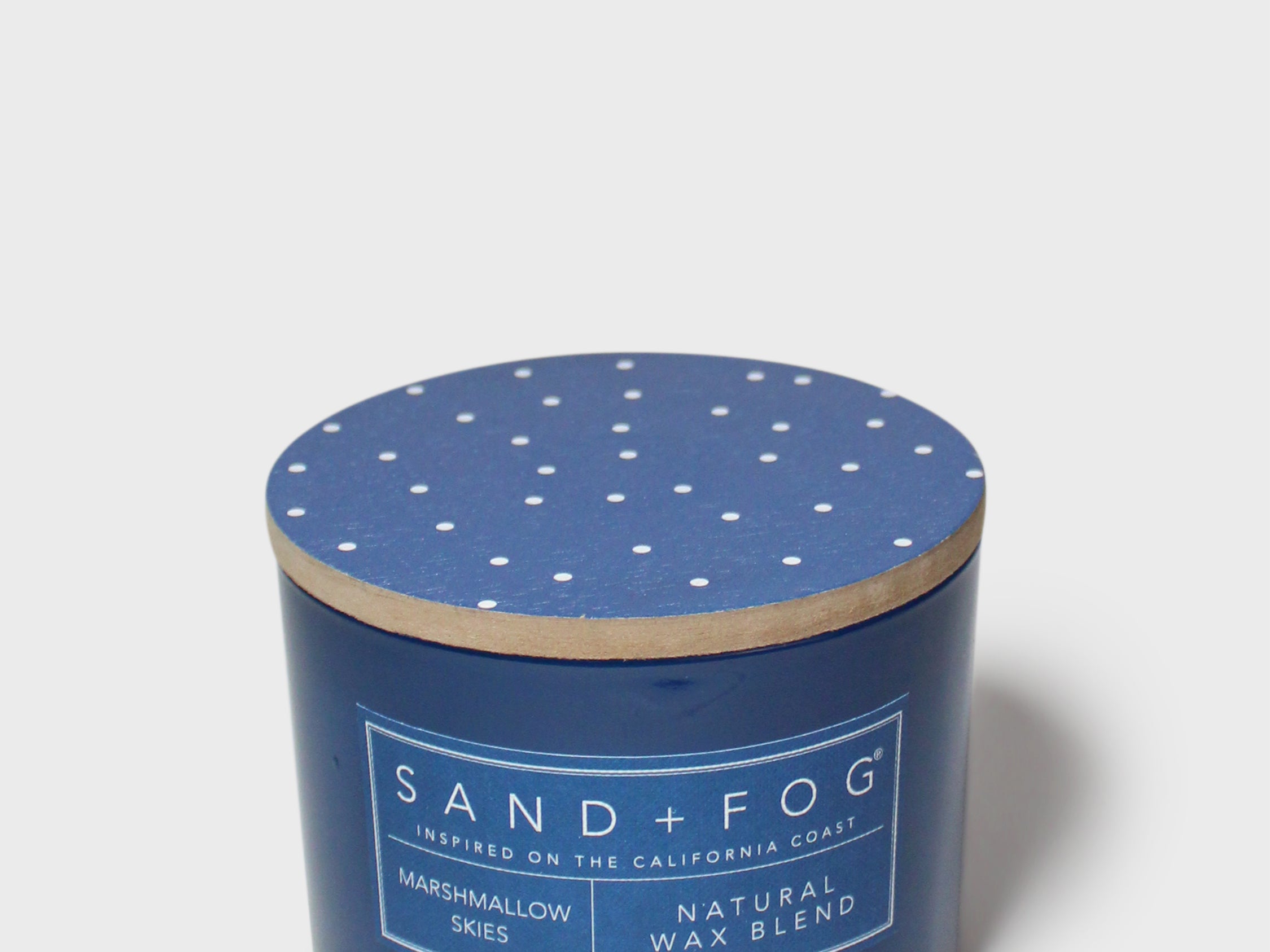 Blue scented candle in round glass jar, speckled lid, printed label with natural wax blend