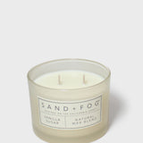 Vanilla-sugar scented candle in clear glass jar with two wicks and label