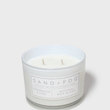 Scented candle in white glass jar with label; cedarwood & rose; two wicks