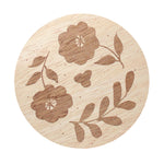 Candle lid with engraved floral pattern and leaf details