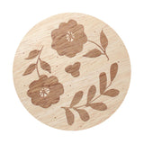 Candle lid with engraved floral pattern and leaf details