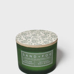 SAND + FOG Italian Bergamot scented candle in green glass jar with white botanical lid label