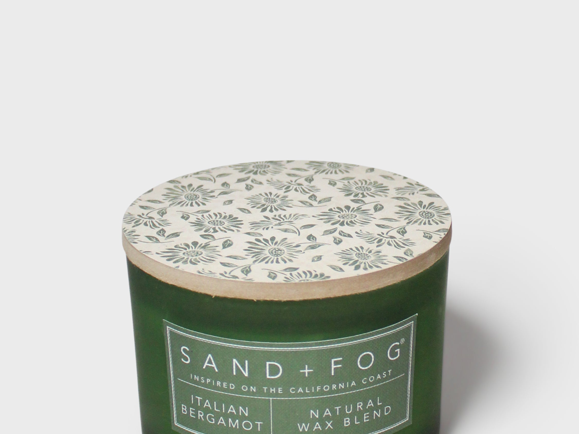 SAND + FOG Italian Bergamot scented candle in green glass jar with white botanical lid label