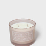 Scented candle in frosted glass jar with two wicks and Vanilla label
