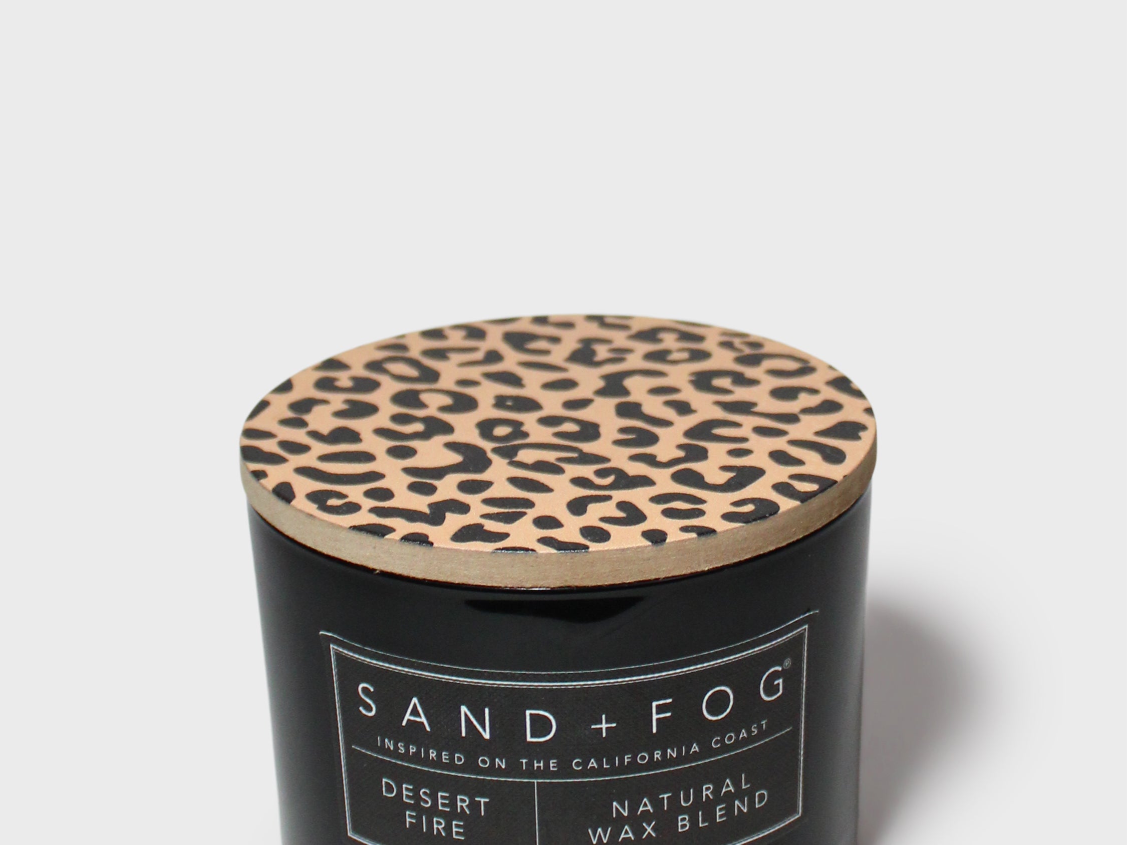 SAND+FOG scented candle in black jar with leopard-pattern lid