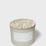Sage green scented candle jar with botanical lid and label