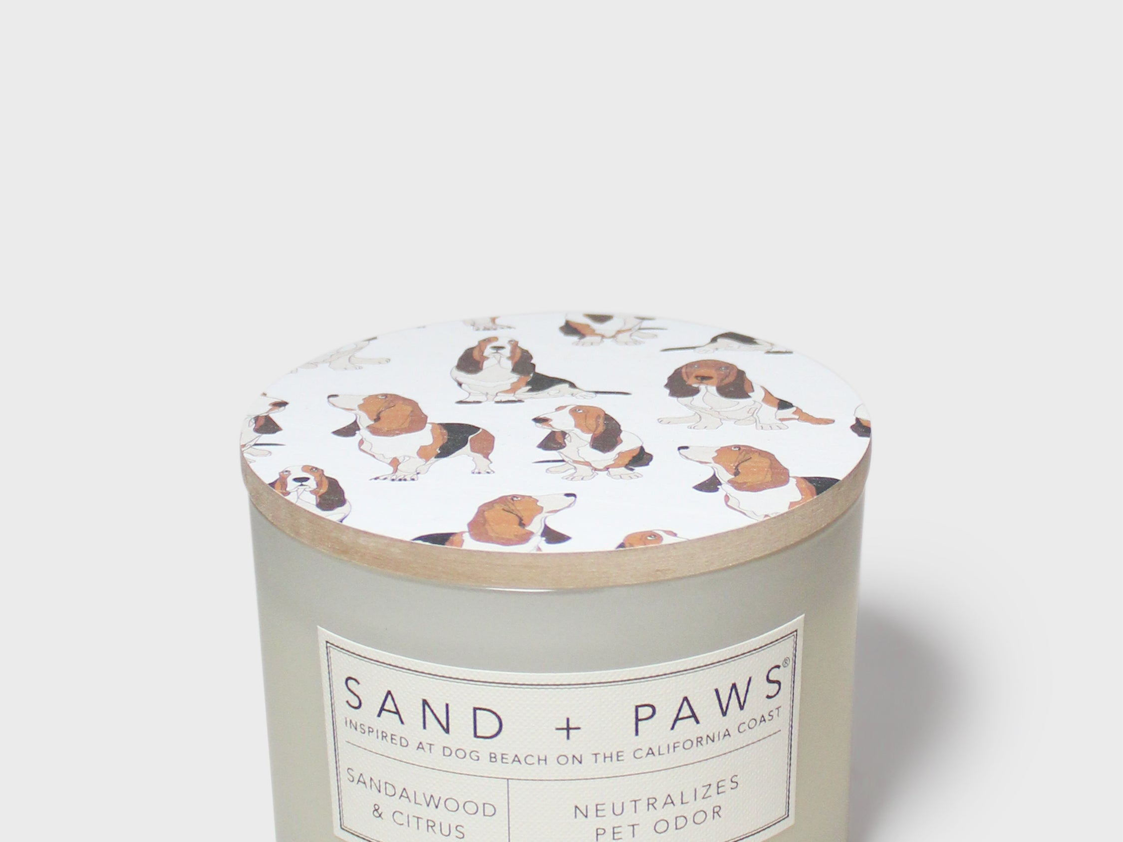 Sandalwood & Citrus scented candle jar with dog-print lid and label