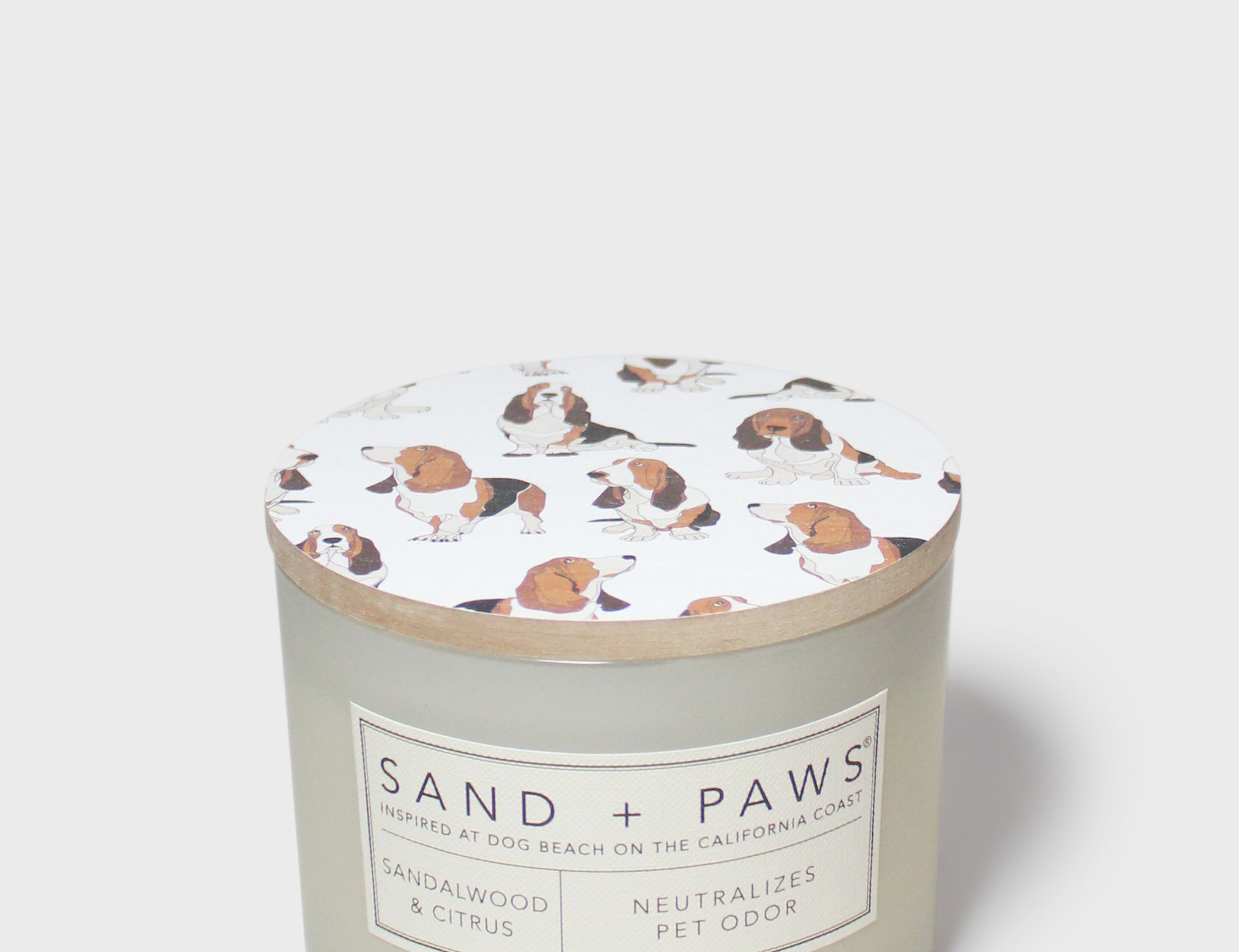 Sandalwood & Citrus scented candle jar with dog-print lid and label