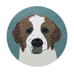 Dog-face graphic on top of scented candle lid in teal and tan