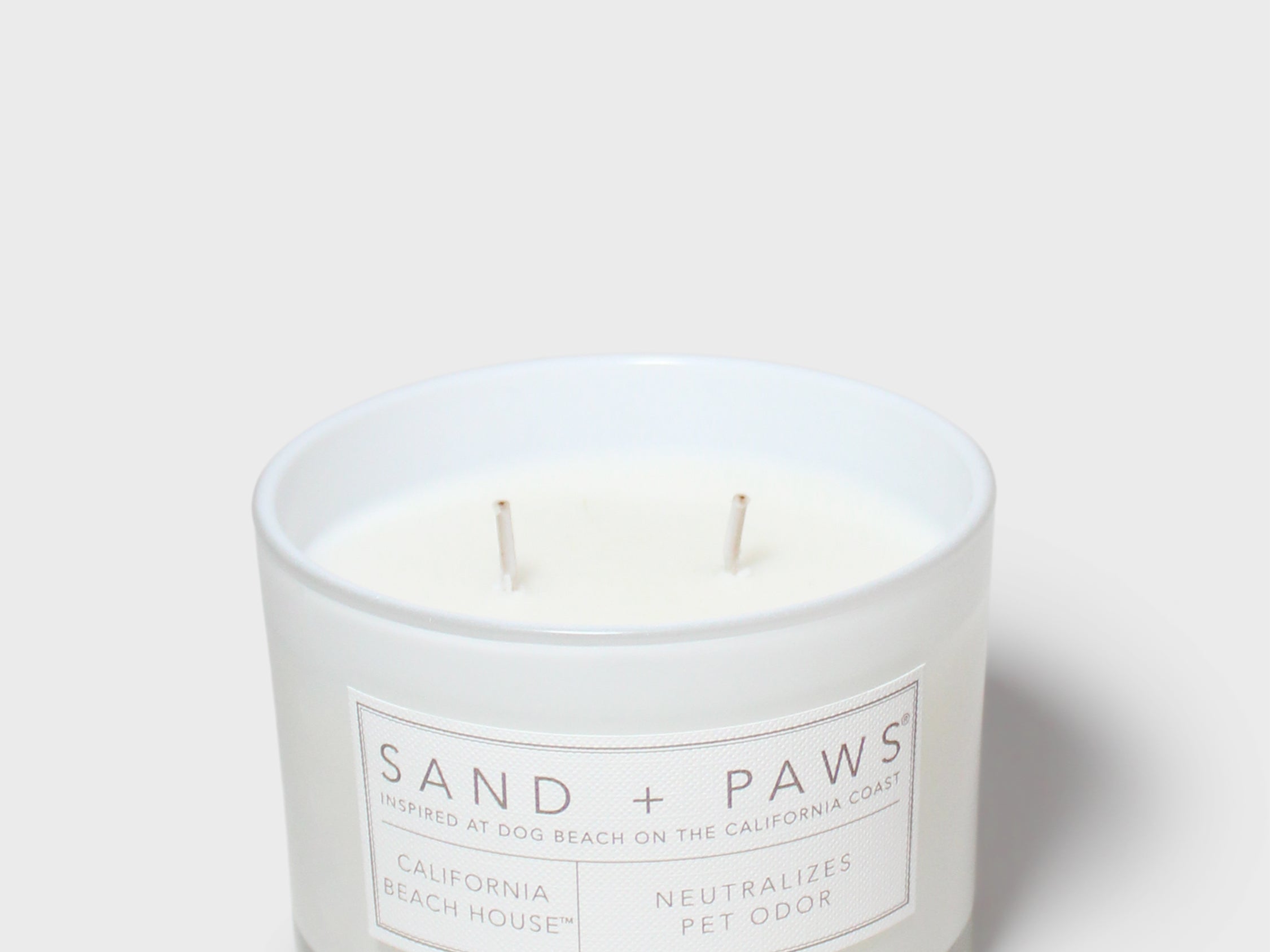 12 oz scented candle in white glass jar with two wicks and label