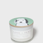 Scented candle jar with dog-face lid and printed scent label