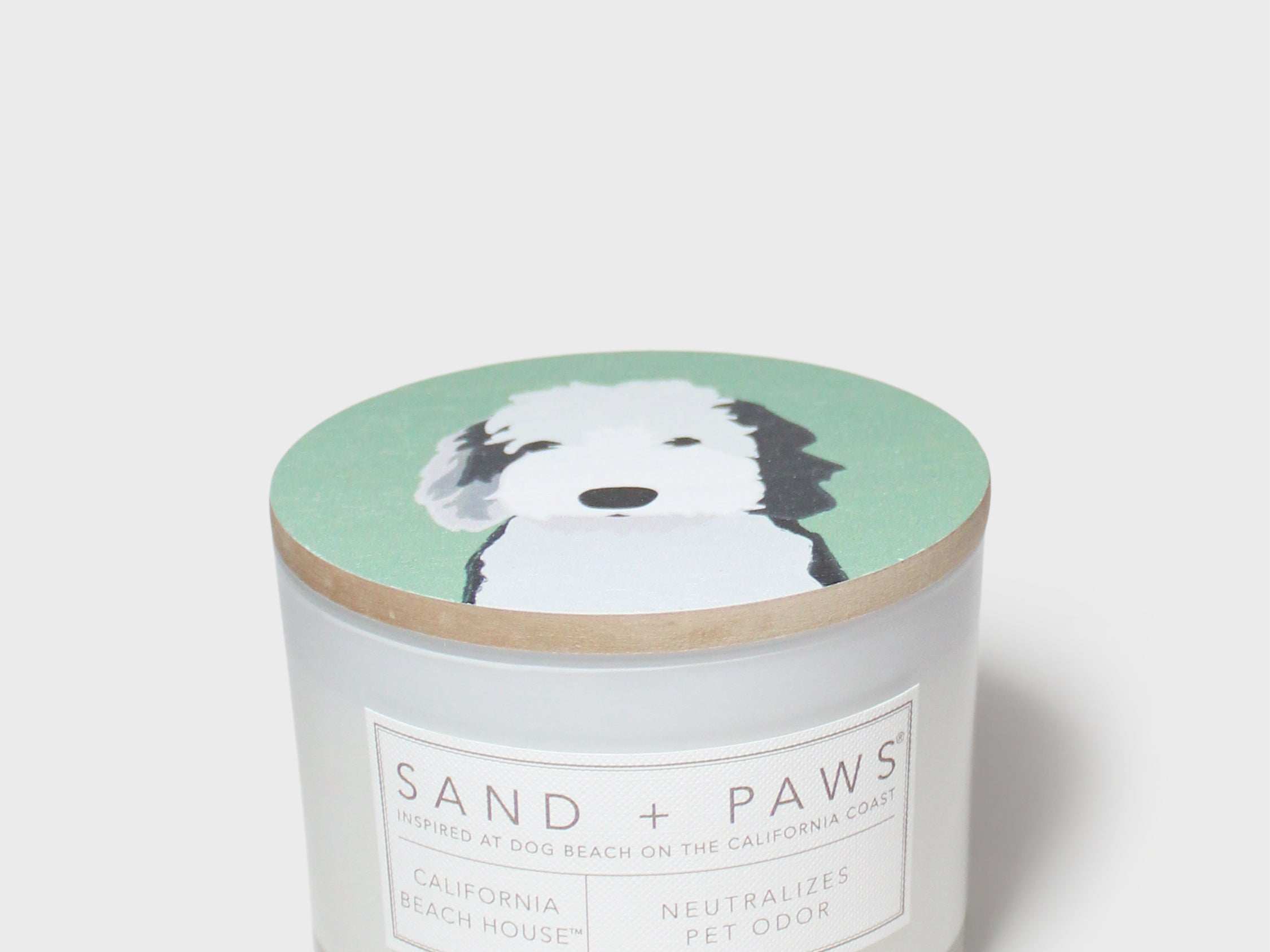 Scented candle jar with dog-face lid and printed scent label
