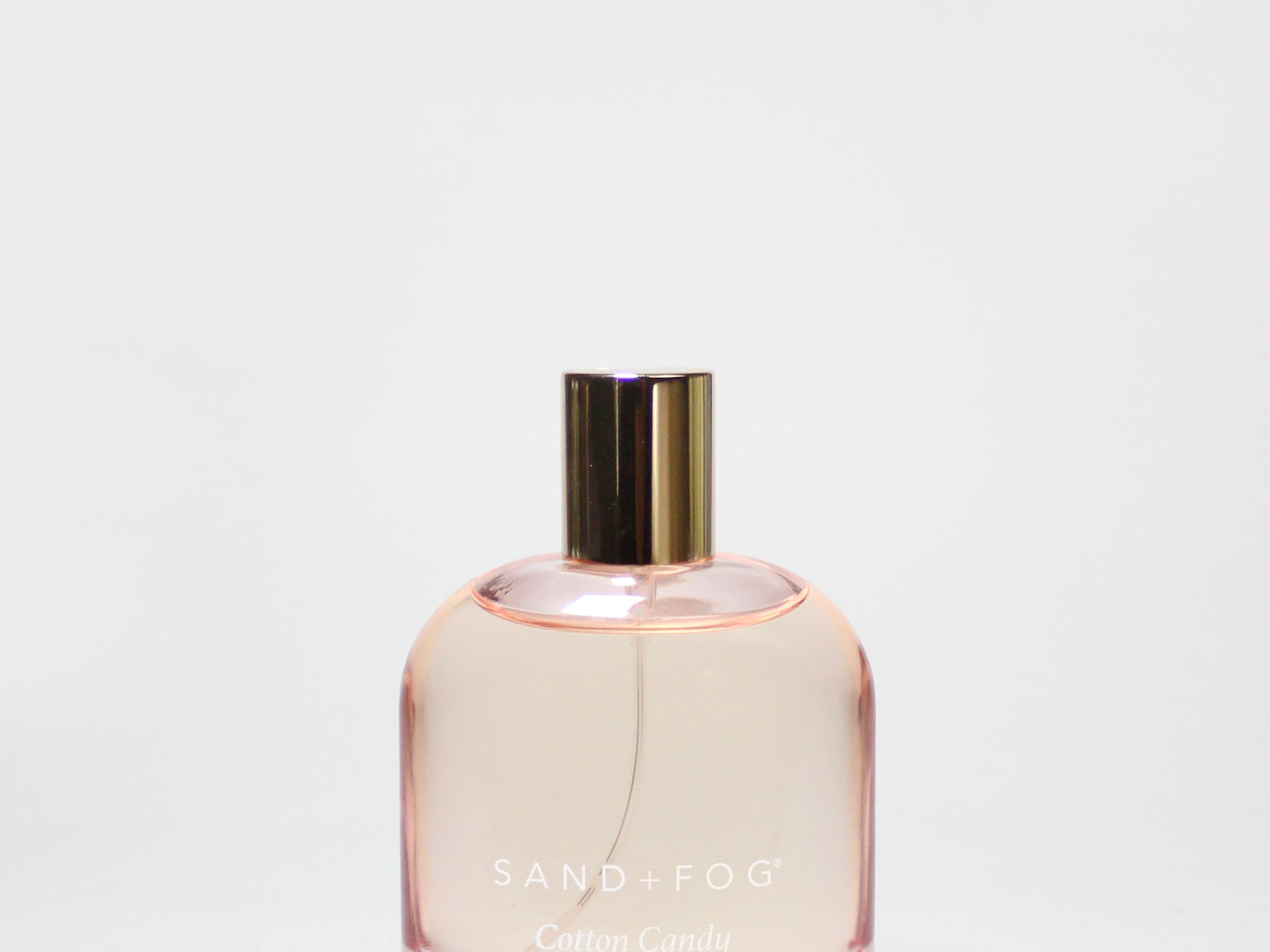 Perfume body oil bottle with pink glass and gold cap, label Cotton Candy