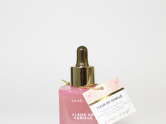 SAND+FOG perfume oil bottle with gold dropper and matching Fleur de Vanille carton