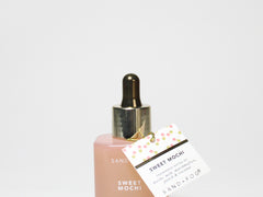 Pink perfume oil bottle with gold dropper cap and Sweet Mochi label card