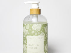 Liquid hand soap bottle with white pump and light green Basil & Neroli label