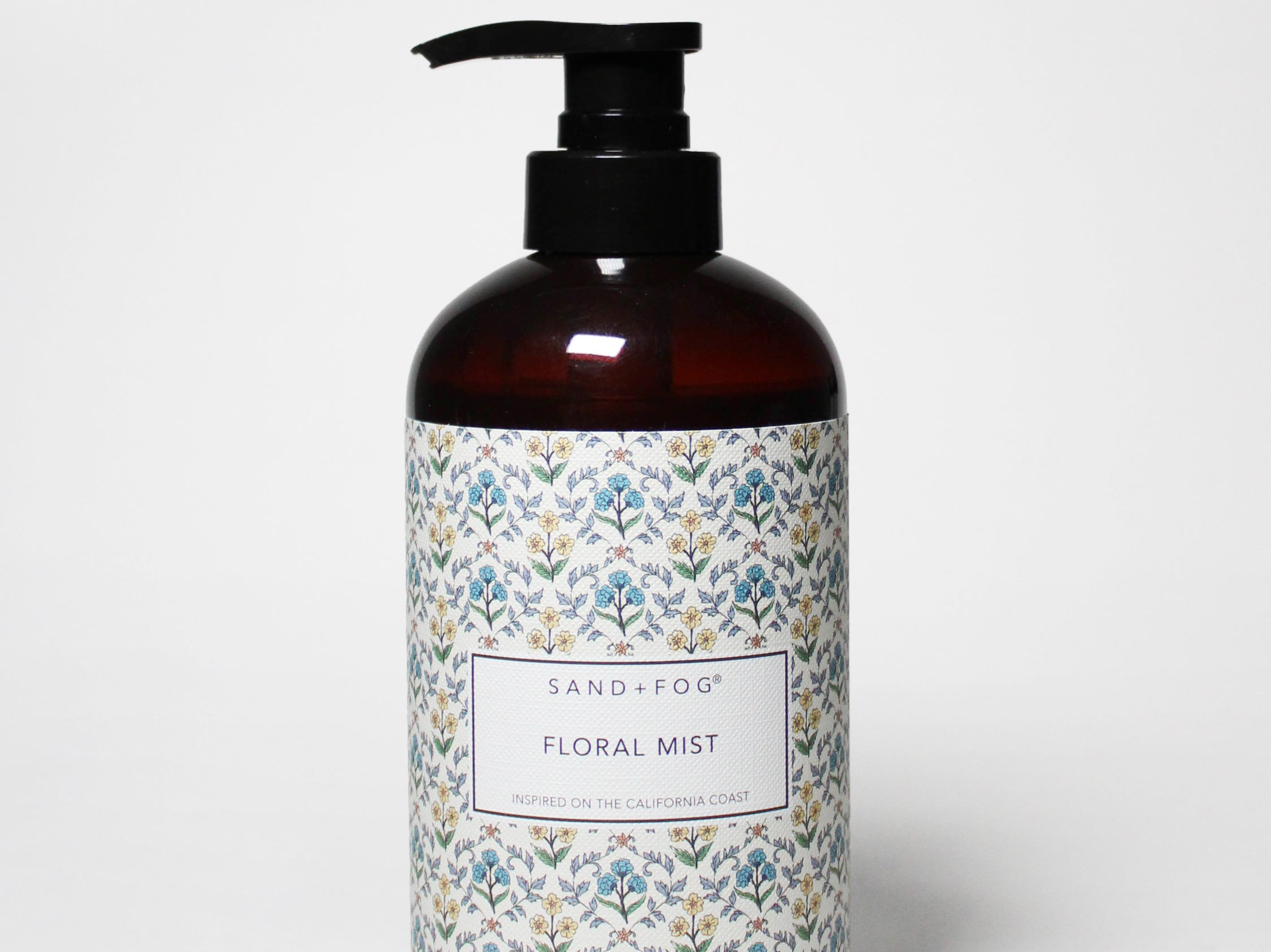 Floral hand soap bottle with amber glass and black pump, floral label
