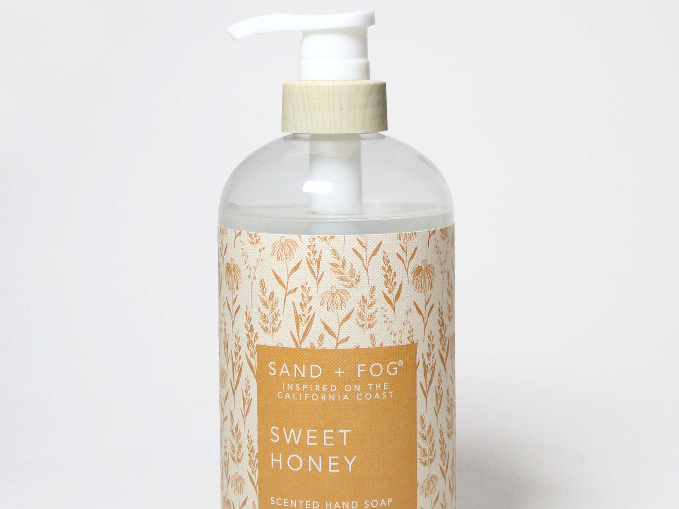 Liquid hand soap bottle with white pump, amber gel, Sand & Fog Sweet Honey label.