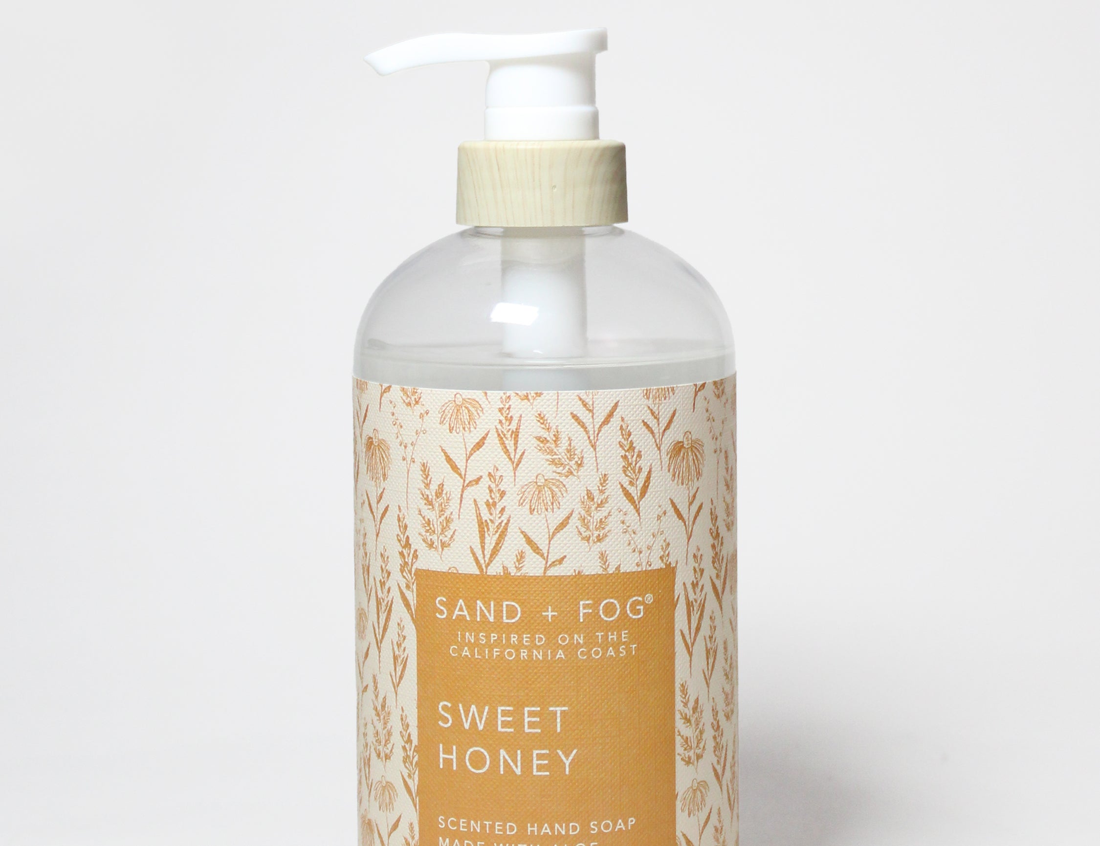 Liquid hand soap bottle with white pump, amber gel, Sand & Fog Sweet Honey label.