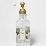 Clear liquid hand soap bottle with gold pump and pine tree label