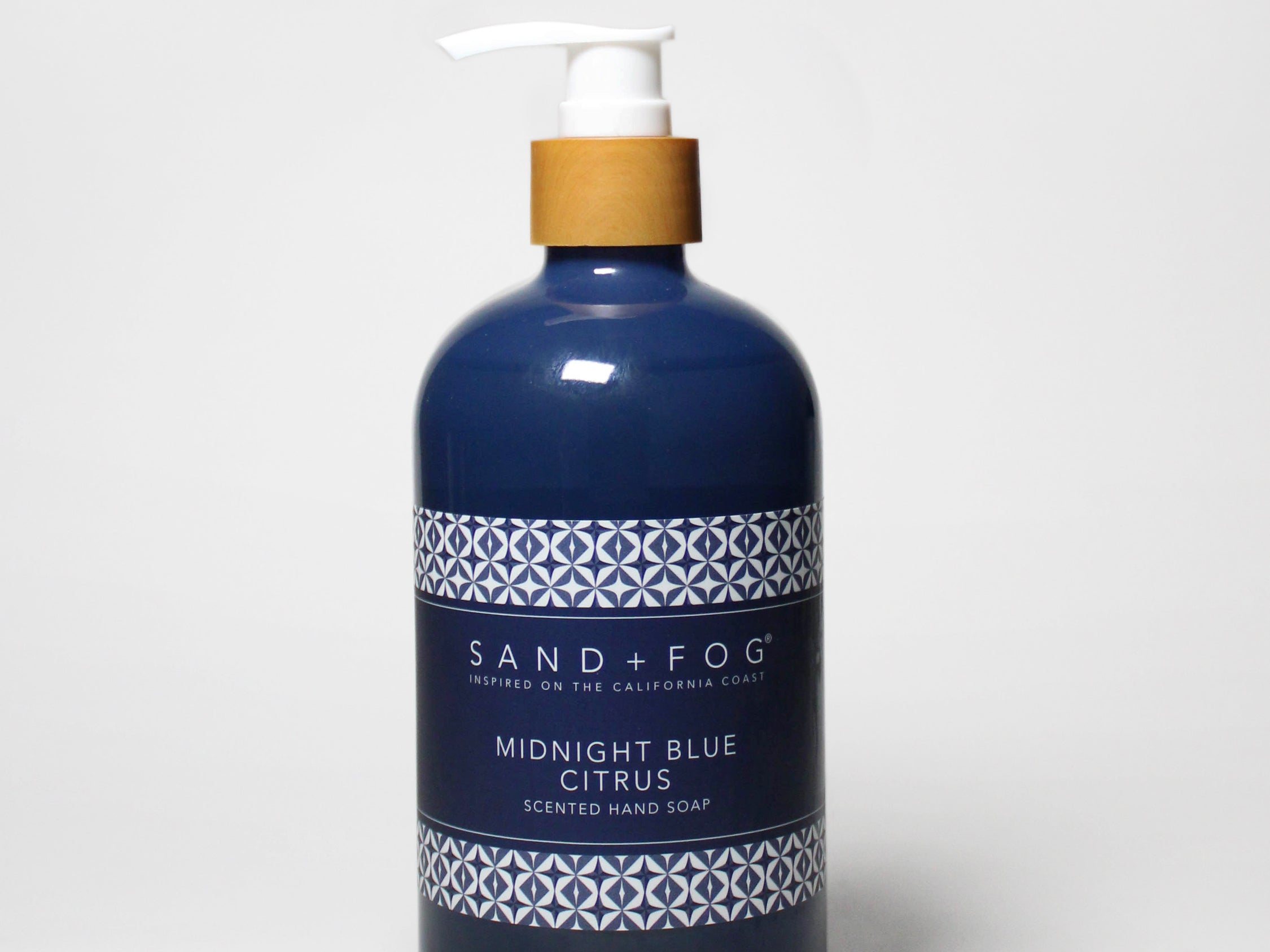 Midnight blue liquid hand soap bottle with pump and citrus label