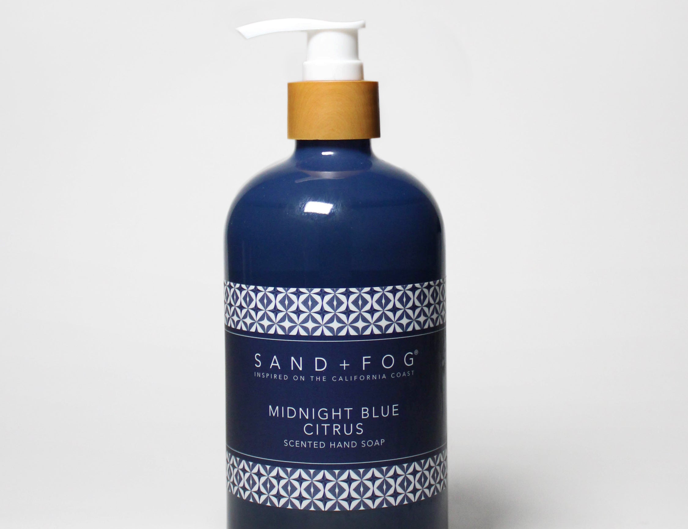 Midnight blue liquid hand soap bottle with pump and citrus label