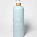 Sand + Paws dog shampoo and conditioner bottle, light blue with pump and paw logo