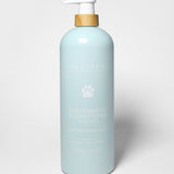 Sand + Paws dog shampoo and conditioner bottle, light blue with pump and paw logo