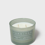 Green glass jar scented candle with cream lid, exposed wax and wicks, 12 oz