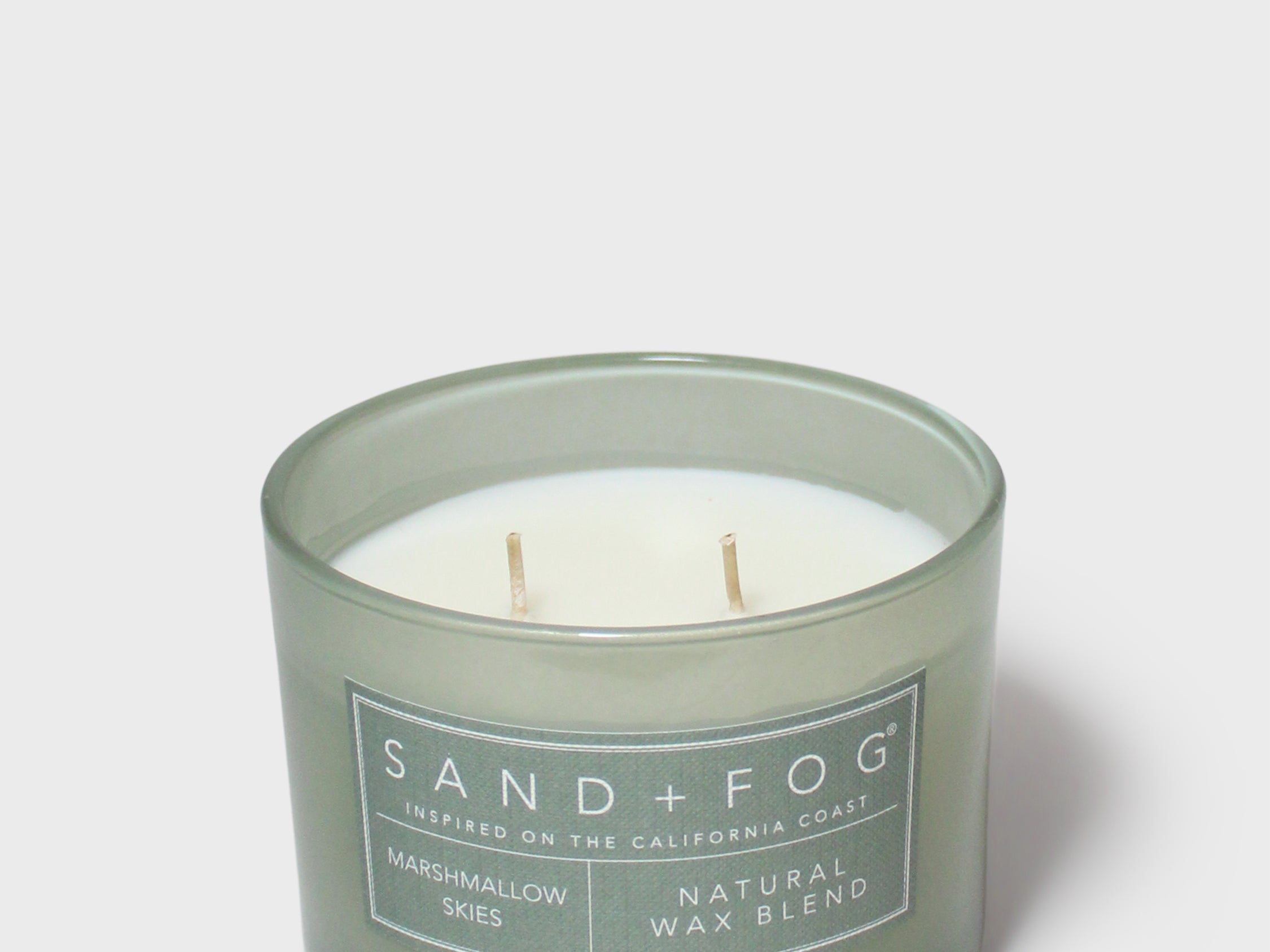 Green glass jar scented candle with cream lid, exposed wax and wicks, 12 oz