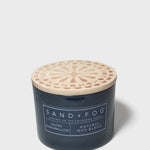 12 oz scented candle in dark blue glass jar with decorative light wood lid