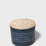 12 oz scented candle in dark blue glass jar with decorative light wood lid