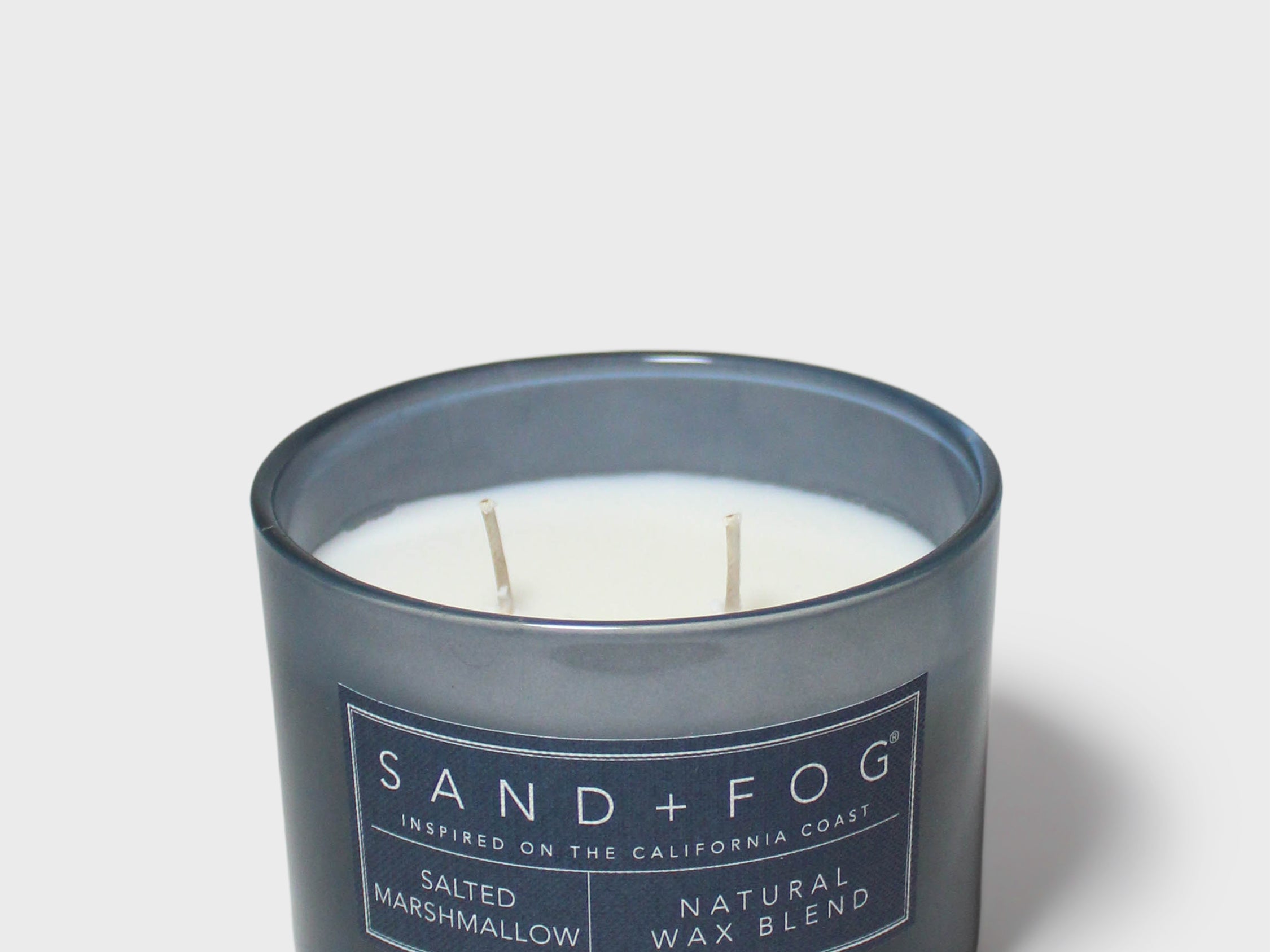 12 oz scented candle in dark blue glass jar with two wicks, Sand + Fog label
