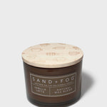 12 oz scented candle in dark brown glass jar with patterned light wax lid