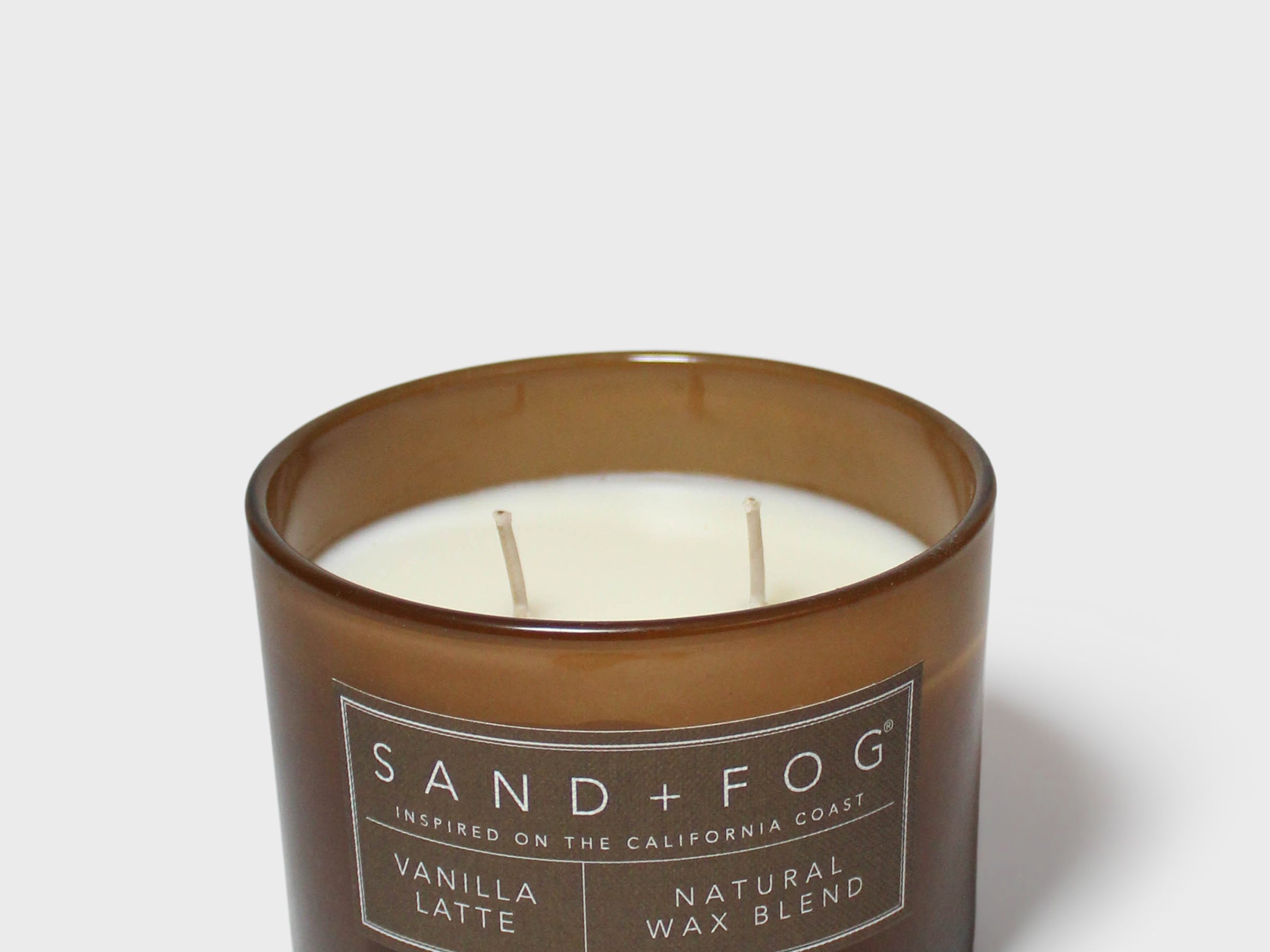 12 oz scented candle in dark brown glass jar with two white wicks