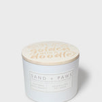 12 oz scented candle with 'golden water' lid and Sand + Paws label