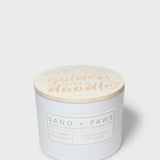 12 oz scented candle with 'golden water' lid and Sand + Paws label