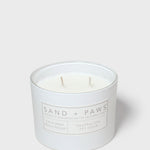 Sand + Paws scented candle in white glass jar with two wicks