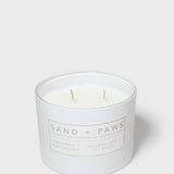 Sand + Paws scented candle in white glass jar with two wicks