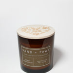 Amber scented candle with wooden lid and Sand + Paws paw-print design